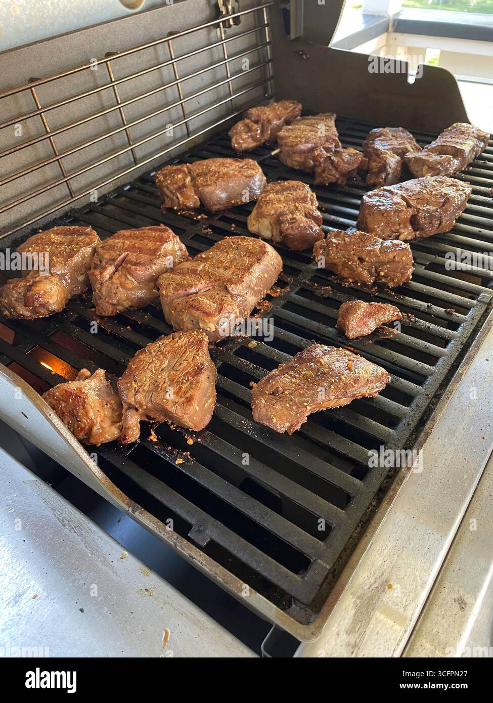 Prime choice filet mignon steaks cooking on a backyard barbecue, 2025, Montana, USA - Smartphone Captured Stock Image