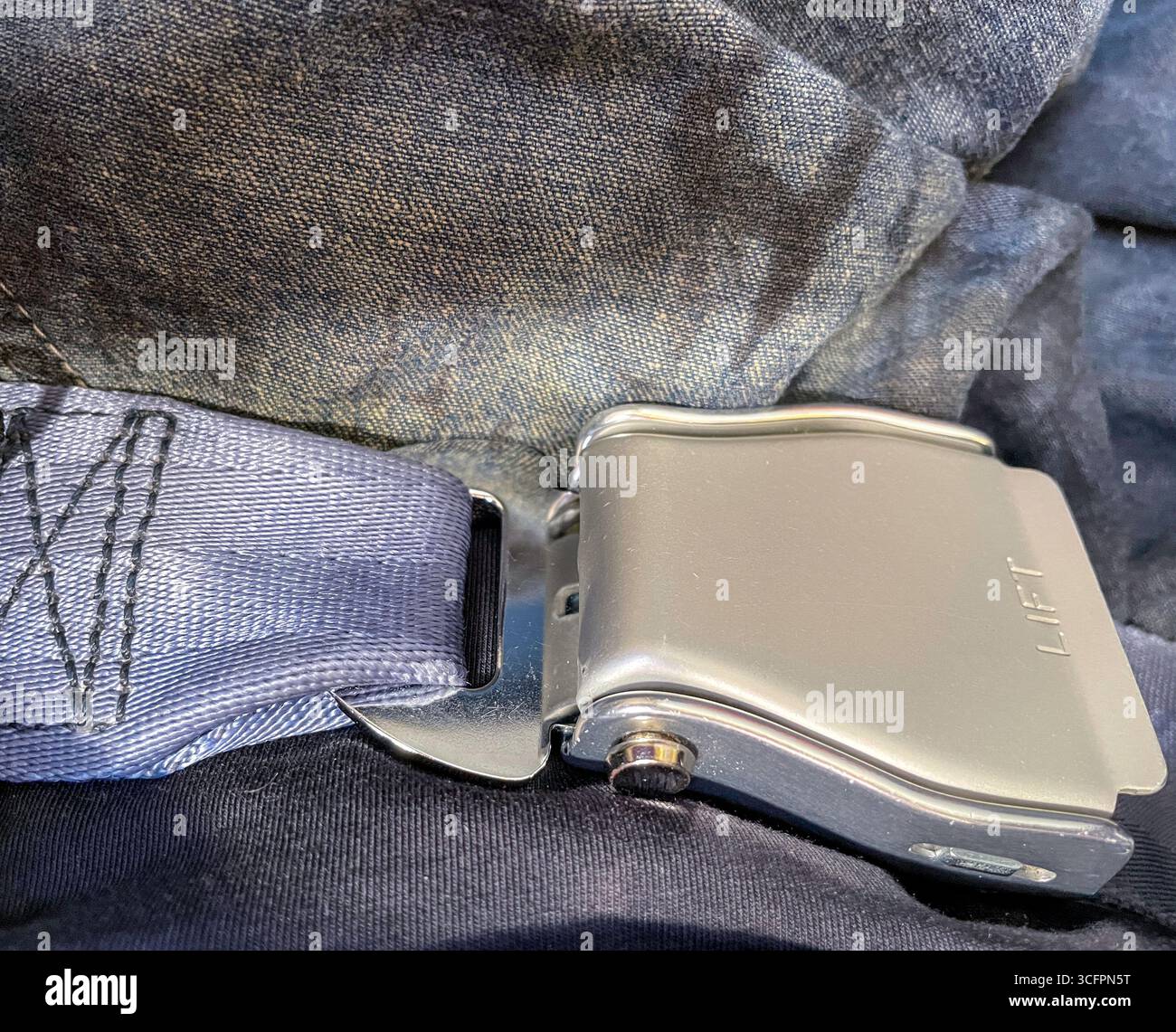 Close up of a seatbelt  in the cabin of a major airline, 2025, United States - Smartphone Captured Stock Image