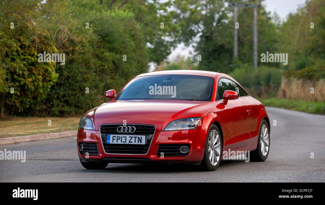 Whittlebury,Norhants,UK - Aug 23rd 2025:  2013 red Audi tt car driving on a British road Stock Photo