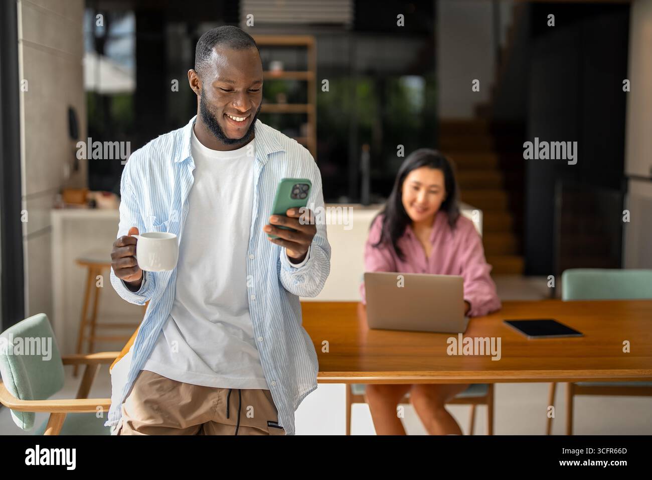 Couple of freelance IT specialists using digital technology devices while working remotely from home Stock Photo