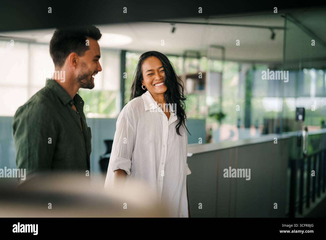 Cheerful diverse coworkers having fun during work break using technology enjoying working together Stock Photo