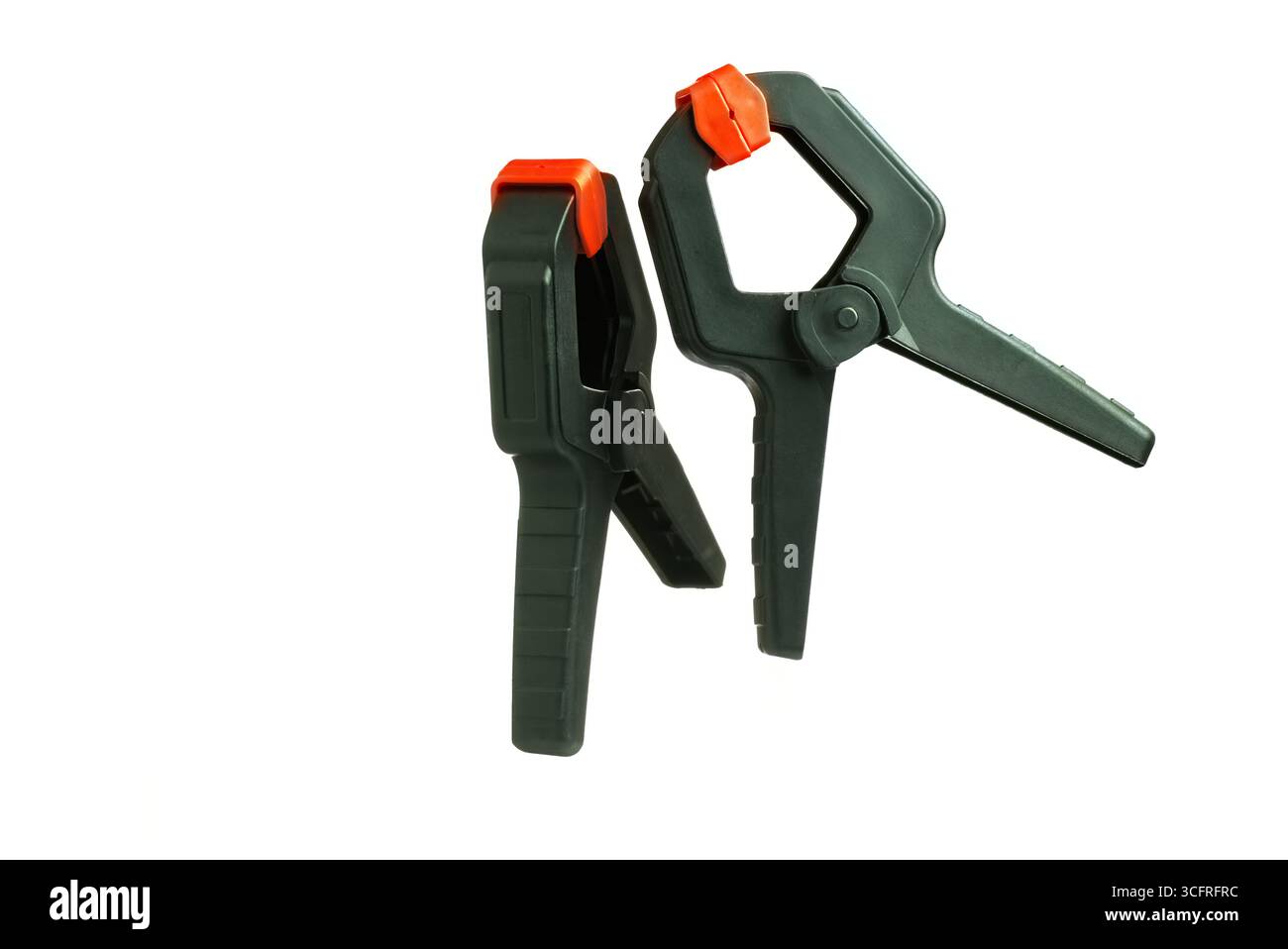 Two black and orange spring clamps on white background Stock Photo