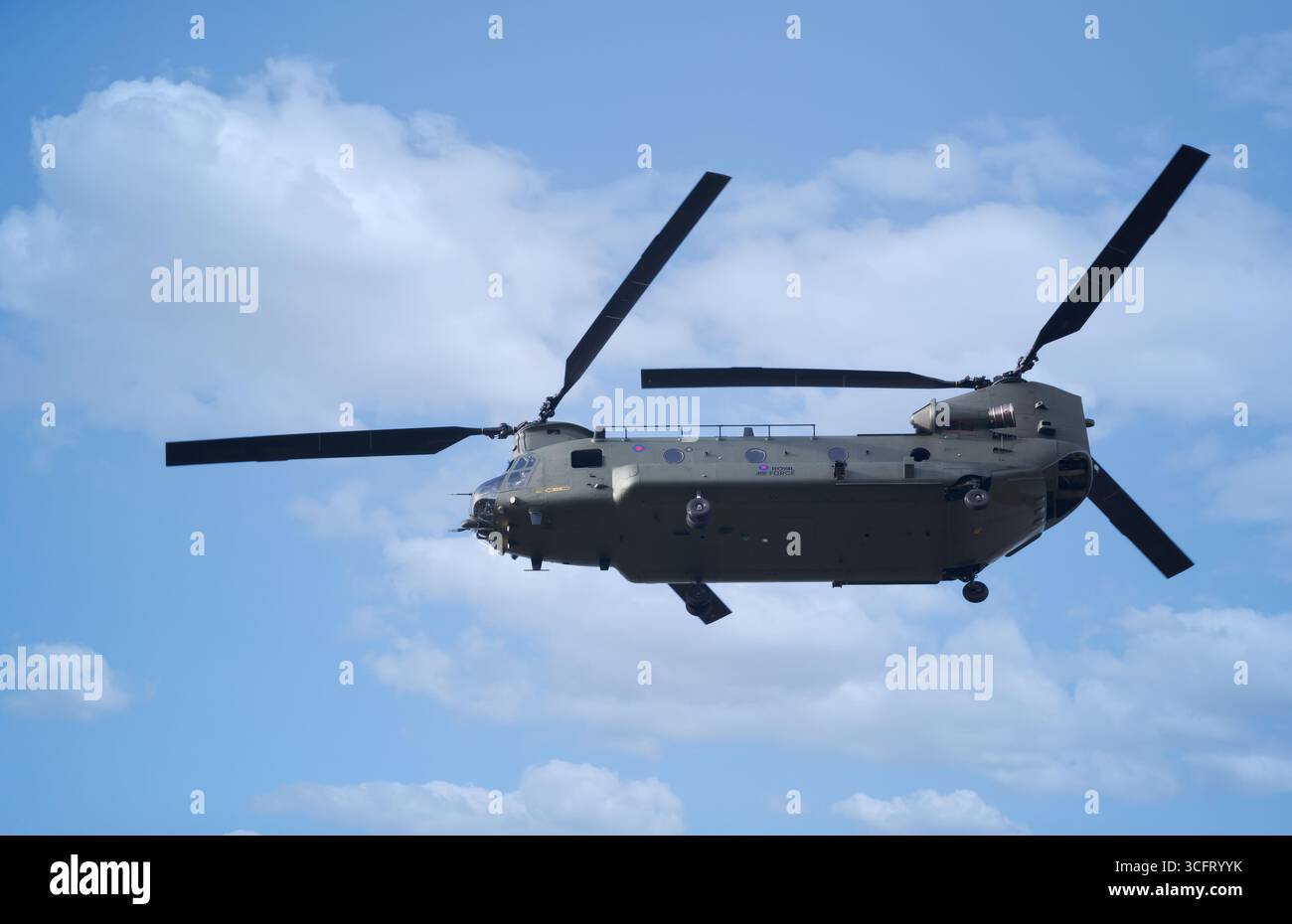 Royal Air Force Boeing CH-47 Chinook helicopter flying in clear sky, UK. Stock Photo