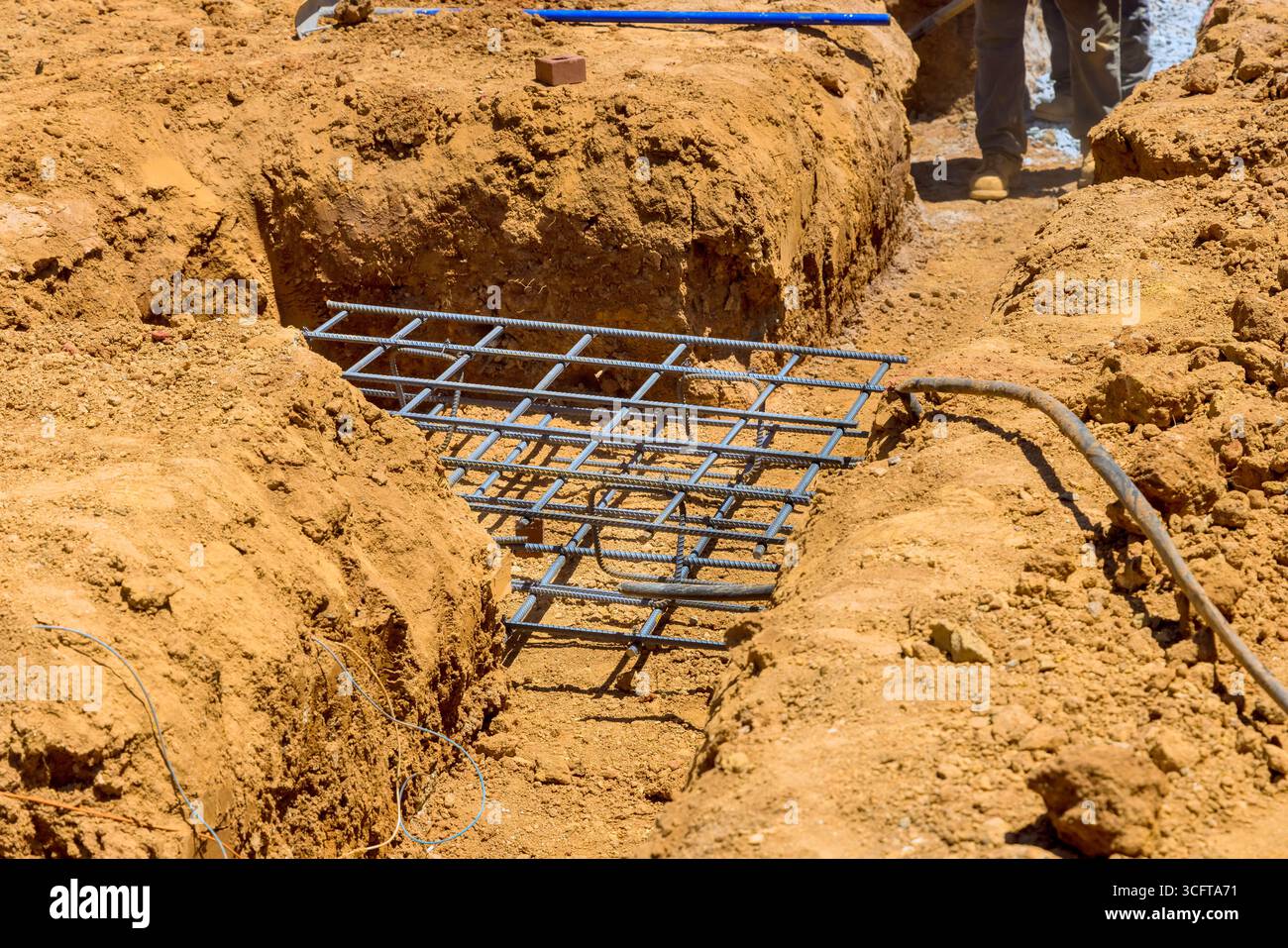 Rebar Work For Raft Workers are preparing solid foundation with rebar grid placed in trench ...