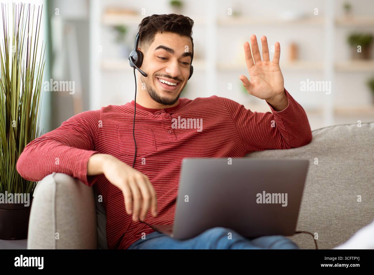 Positive arab guy working from home, having video conference Stock Photo