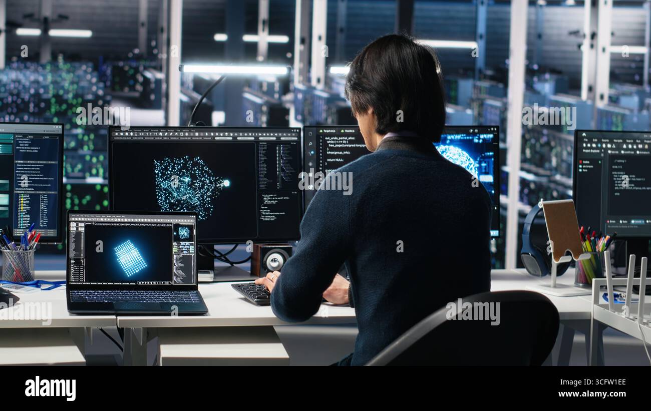 Programmer entering server room office, using AI to review infrastructure diagnostics. IT admin in data center high tech facility analyzes performance data using artificial intelligence tech, camera A Stock Photo