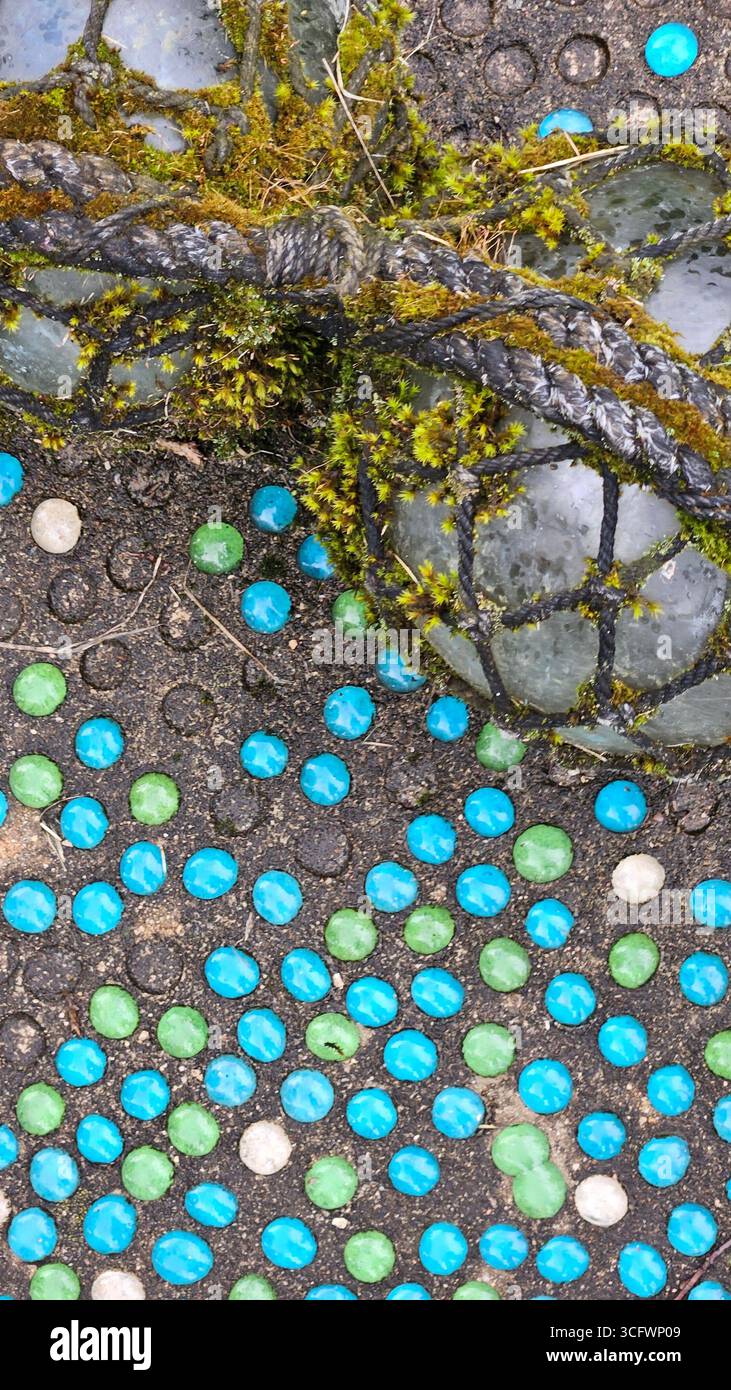 Moss-Covered Glass Fishing Float with Netting - Smartphone Captured Stock Image Moss-Covered Glass Fishing Float with Netting - Smartphone Captured Stock Image