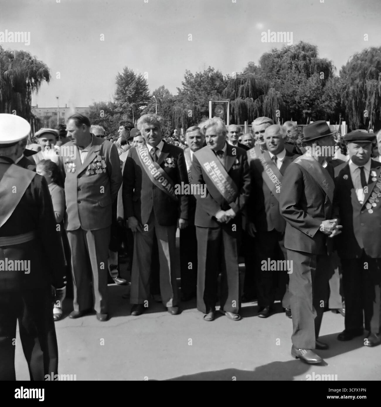 Honoring veterans of war and labor on the Day of the City in Sloviansk, Ukrainian SSR, September 6, 1984. This archival image shows a group of elderly men with medals and honorary sashes at a festive event, documenting the tradition of respecting the older generation and the peaceful life of Donbas before the war Stock Photo