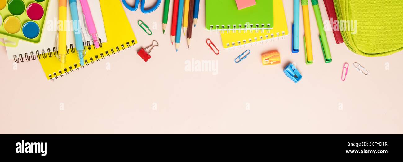 Back to school. School backpack with stationery on colored background. Web banner format. Stock Photo