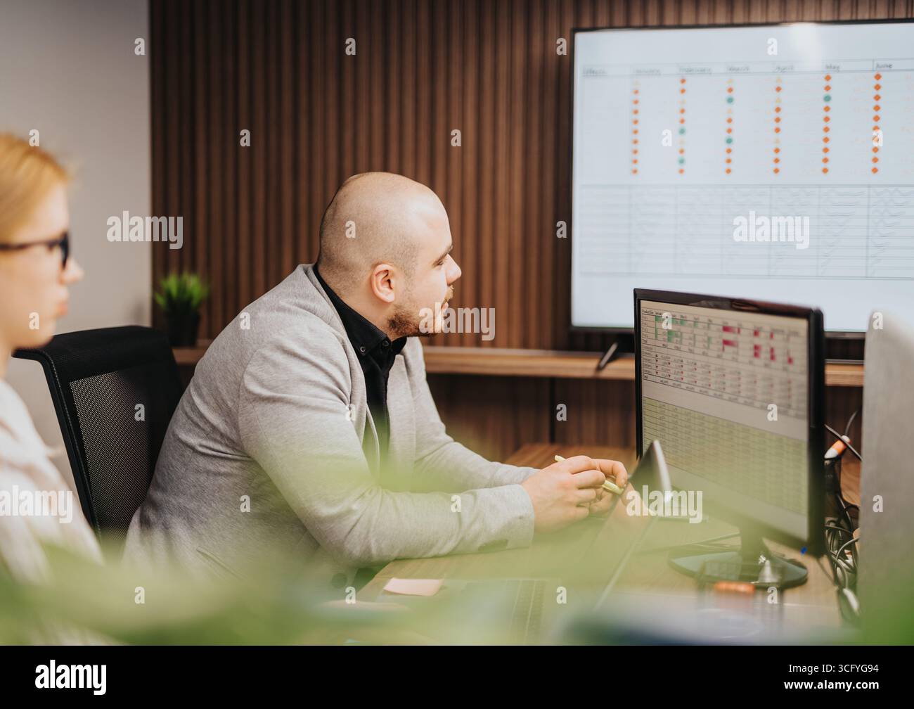 Office team analyzing project data during a business meeting Stock Photo
