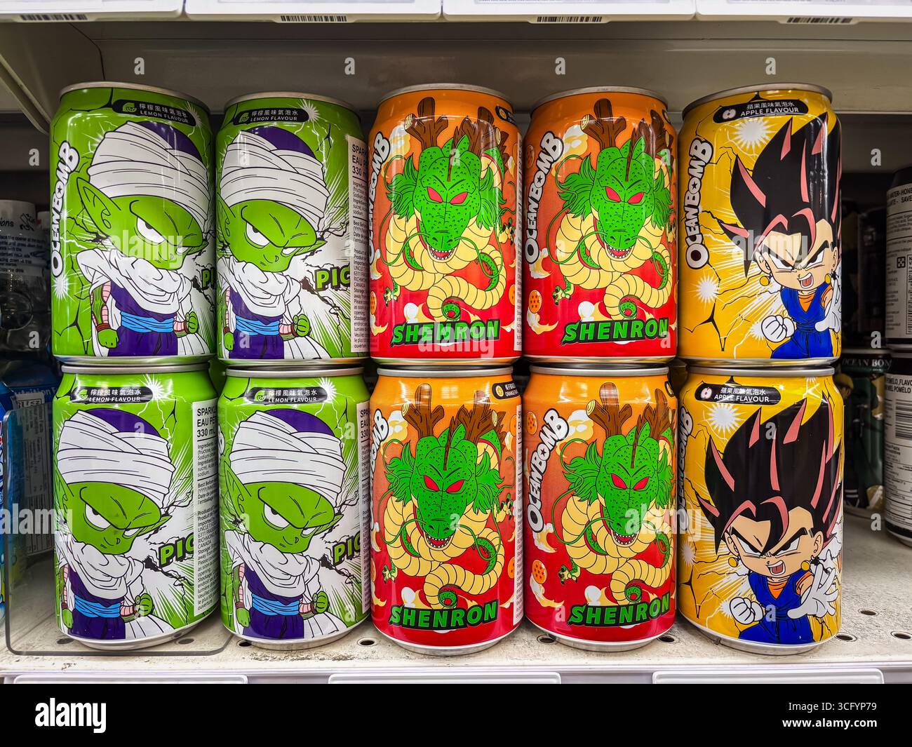 Ocean Bomb sparkling water cans featuring popular Dragon Ball Z anime characters Piccolo, Shenron, and Vegeta. Displayed on a store shelf, showing dif Stock Photo