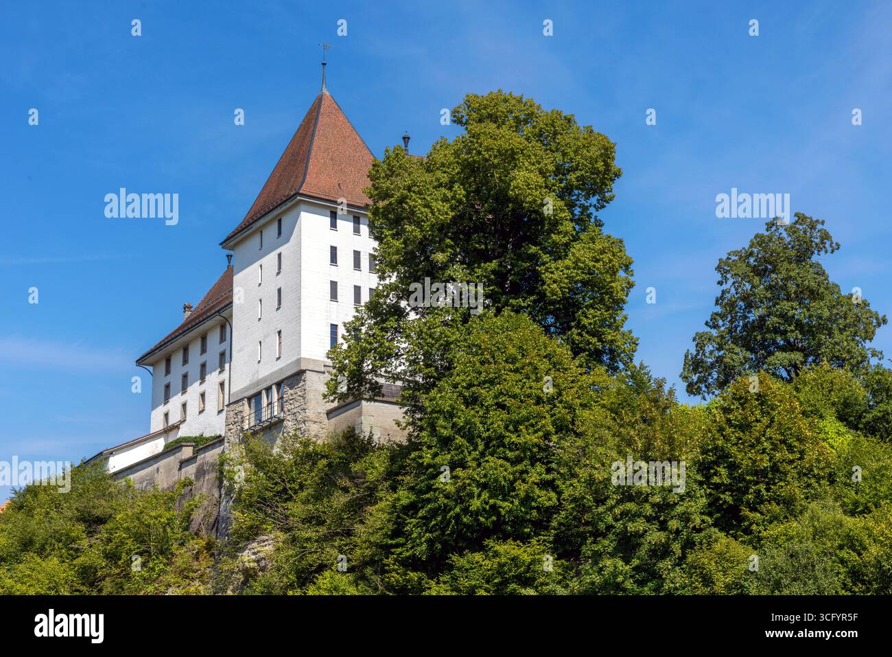 The historic Schloss Sumiswald, a former Teutonic Knights' commandery, now serves as a hotel and event venue overlooking the Emmental hills. Stock Photo