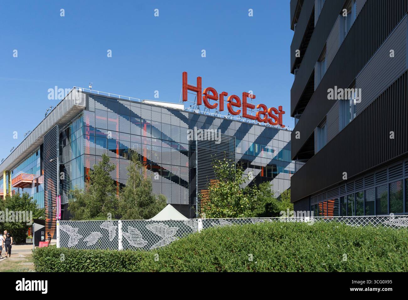 HereEast, a tech hub in Queen Elizabeth Olympic Park, London, stands tall. It fosters innovation and collaboration in East London. Stock Photo