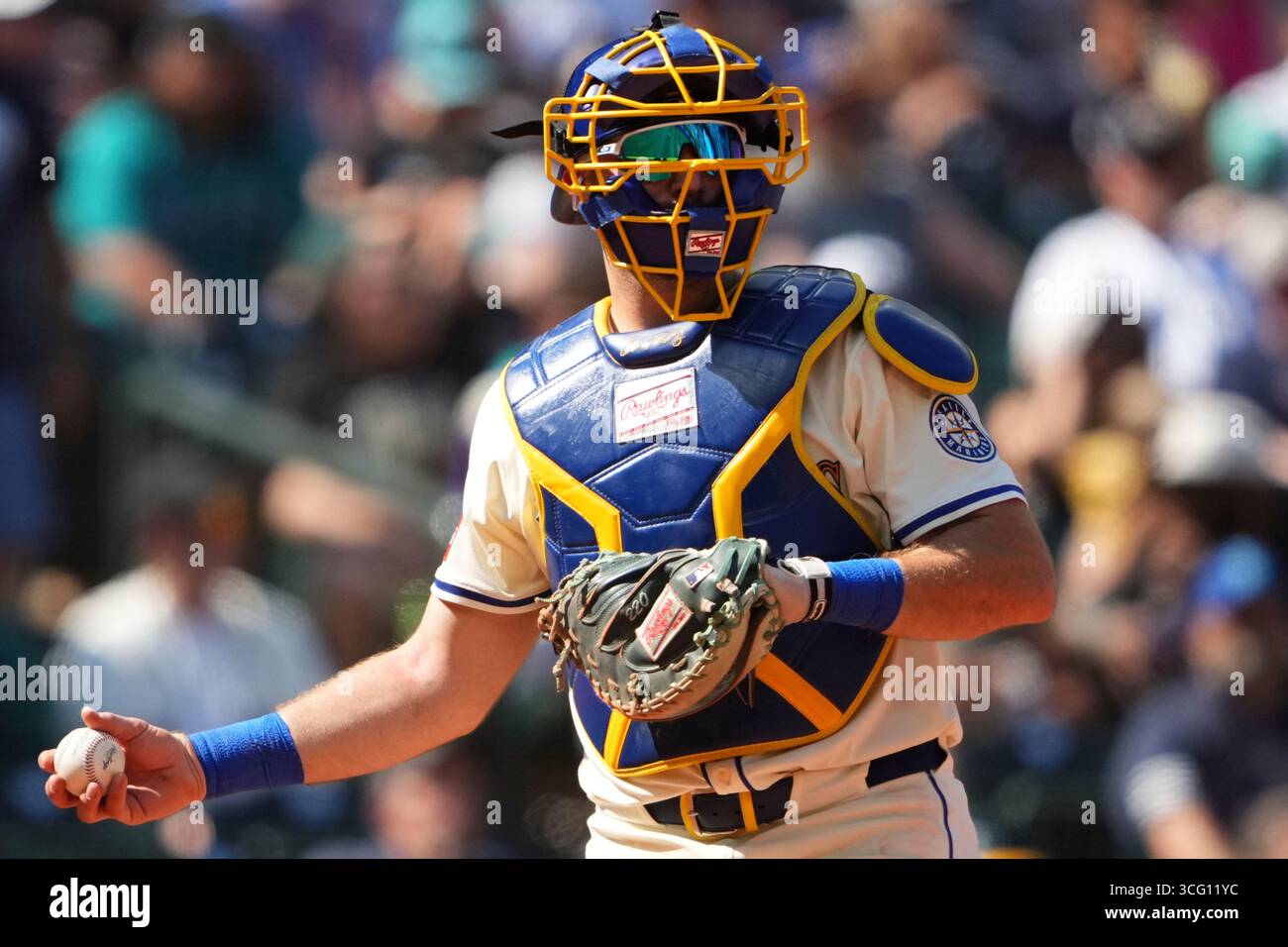 Seattle Mariners catcher Cal Raleigh holds a ball during a baseball ...
