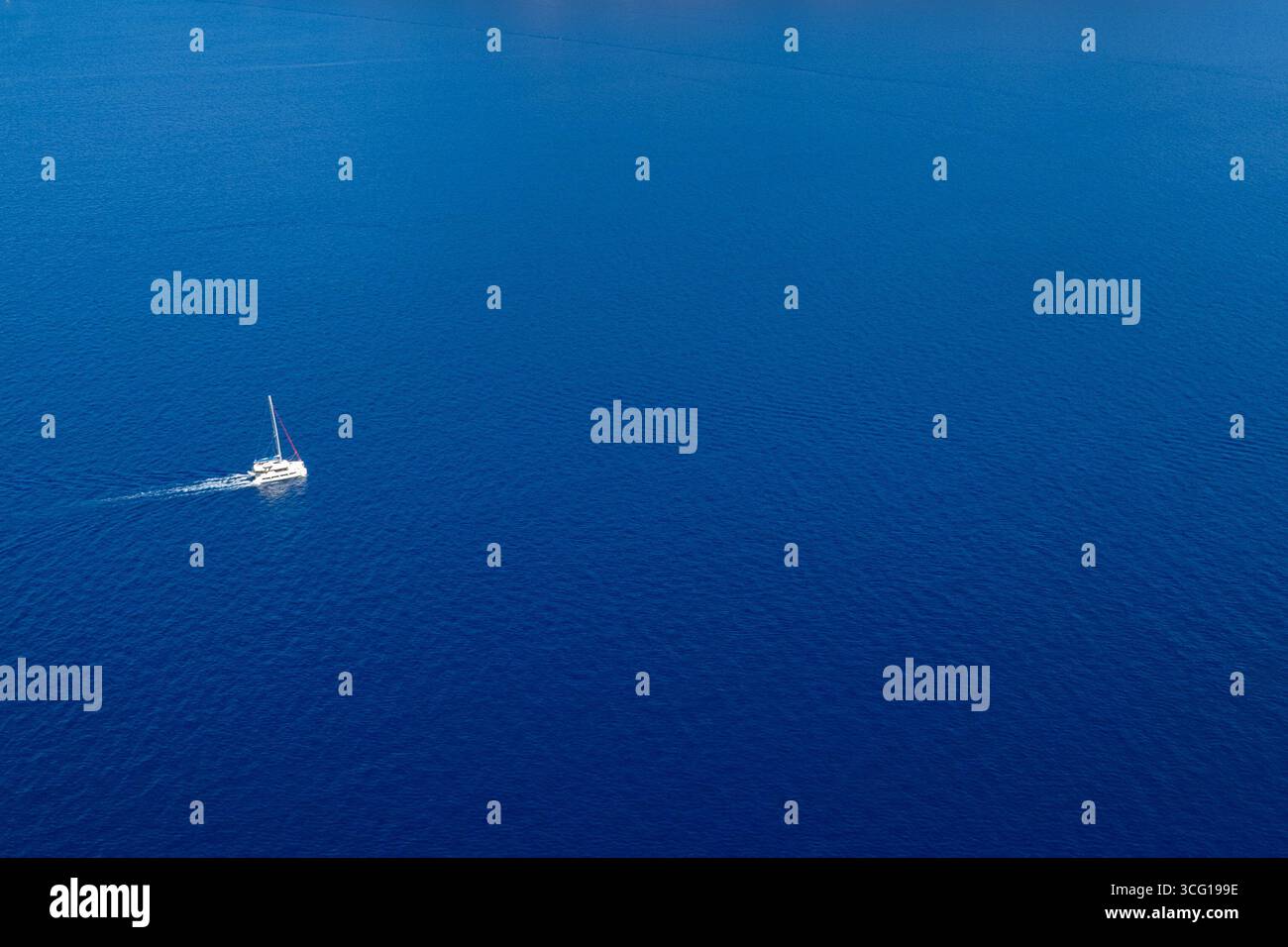 Drone scenery of a sail yacht sailing in the Ionian sea . Turquoise calm sea water. Summer holidays in the ocean Stock Photo