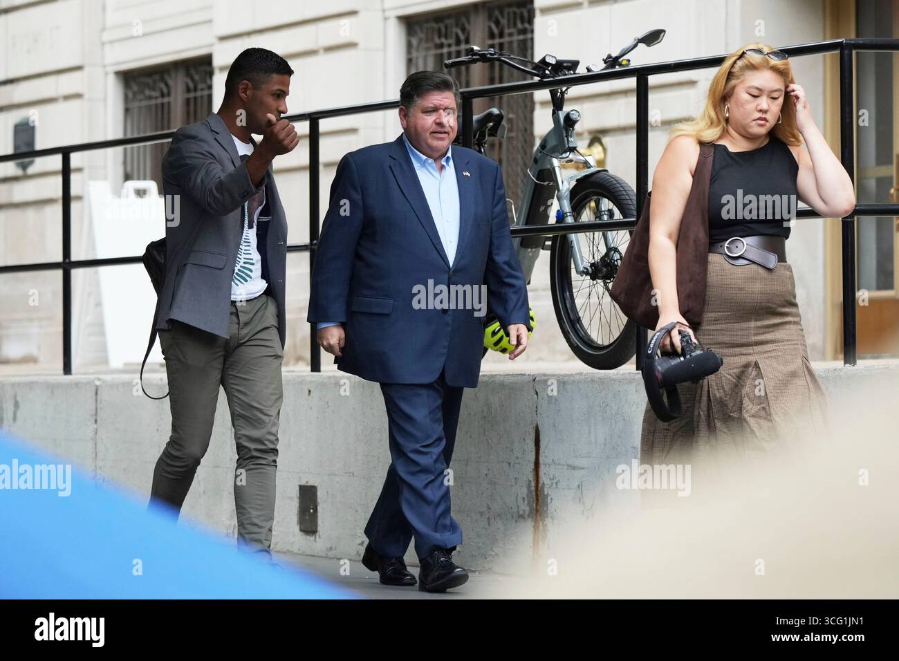 Illinois Governor JB Pritzker walks to a news conference in a Chicago ...