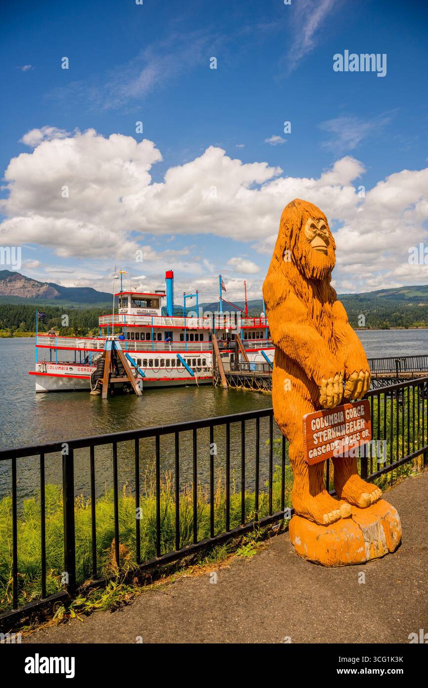 View of the Columbia Gorge Sternwheeler, docked at the town of Cascade Locks, with a Sasquatch statue in the foreground, Oregon, USA. Stock Photo