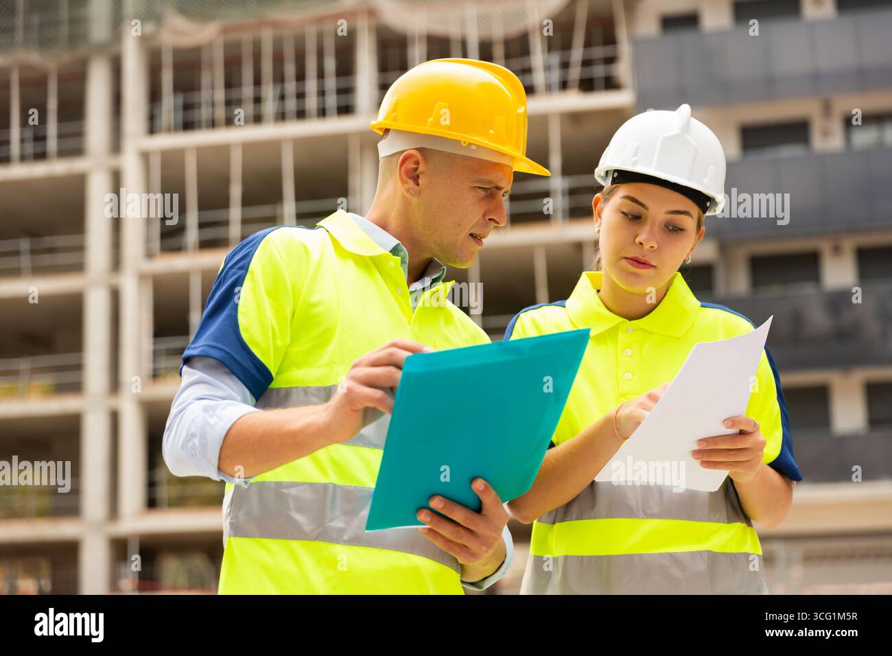 Two qualified engineers are discussing a construction plan Stock Photo