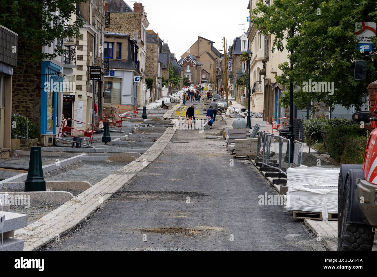 roadworks in the city, a road is being rebuilt and pedestrians do not respecting barriers, France, Brittany, Dinard Stock Photo