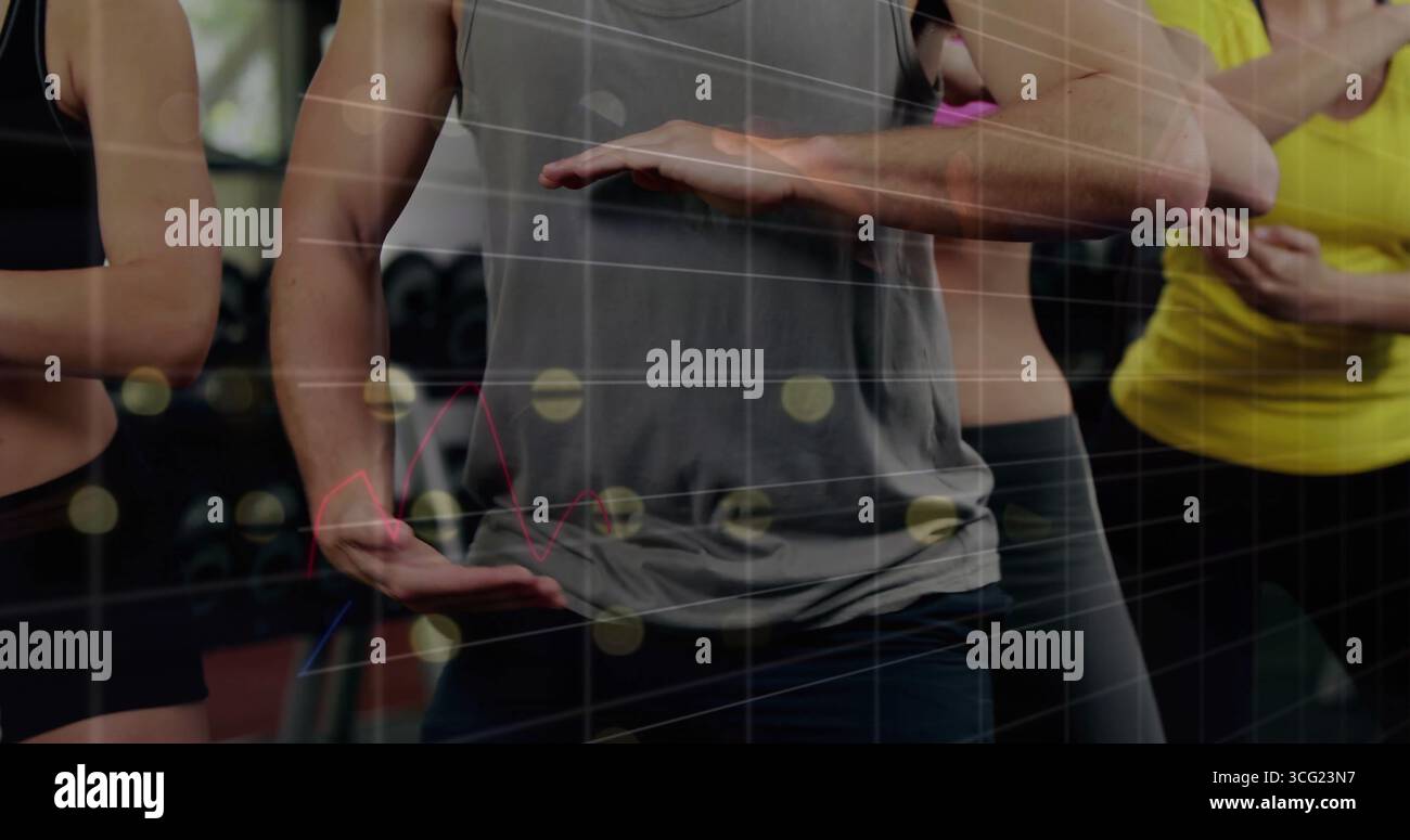 Adults in athletic wear performing tai chi pose in gym studio, with dumbbell rack, grid overlay Stock Photo