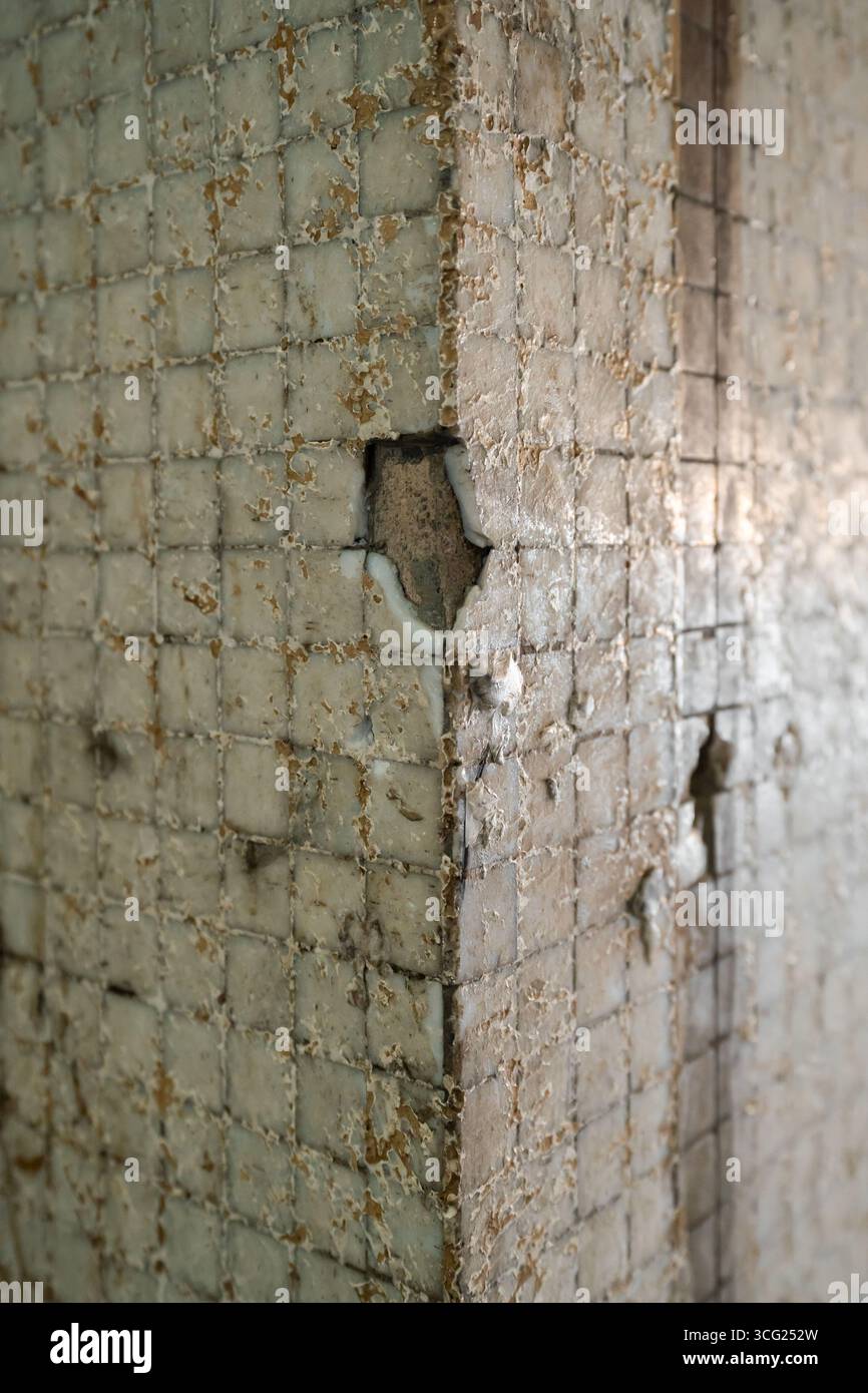 A close-up view of an eroded concrete corner with visible surface ...