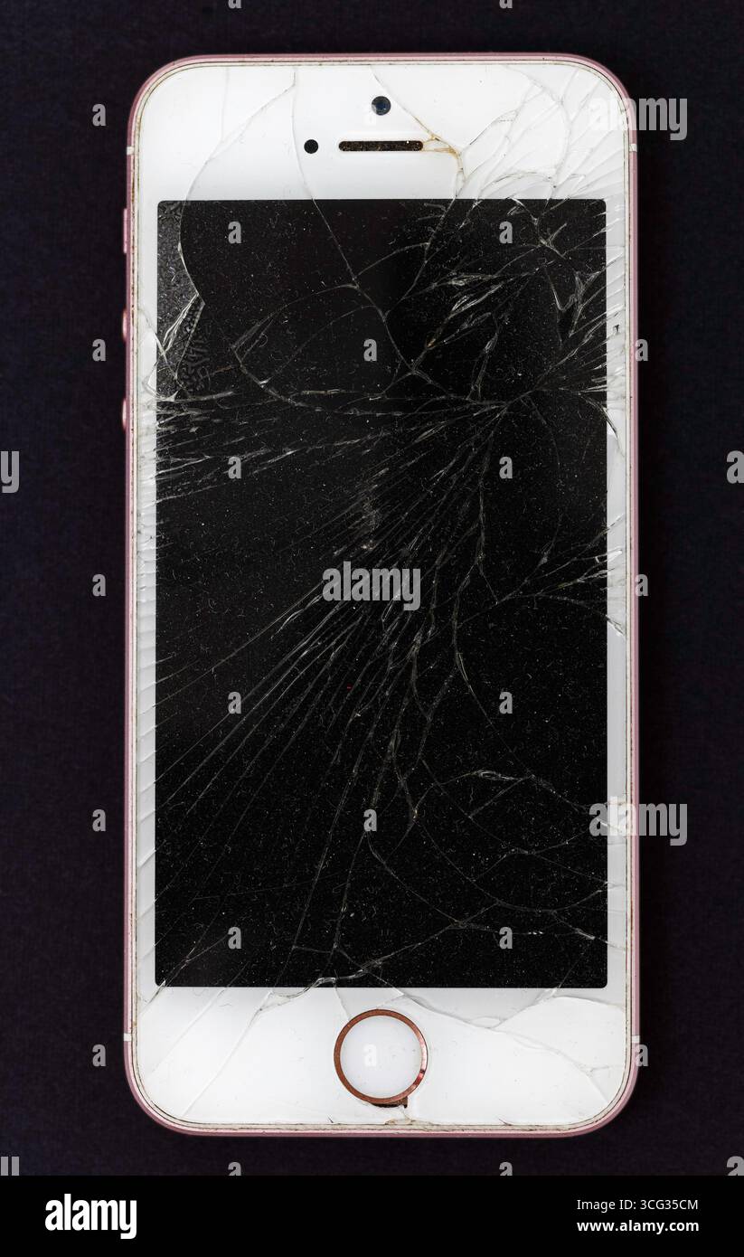 mobile phone, iphone, with cracked screen. Stock Photo