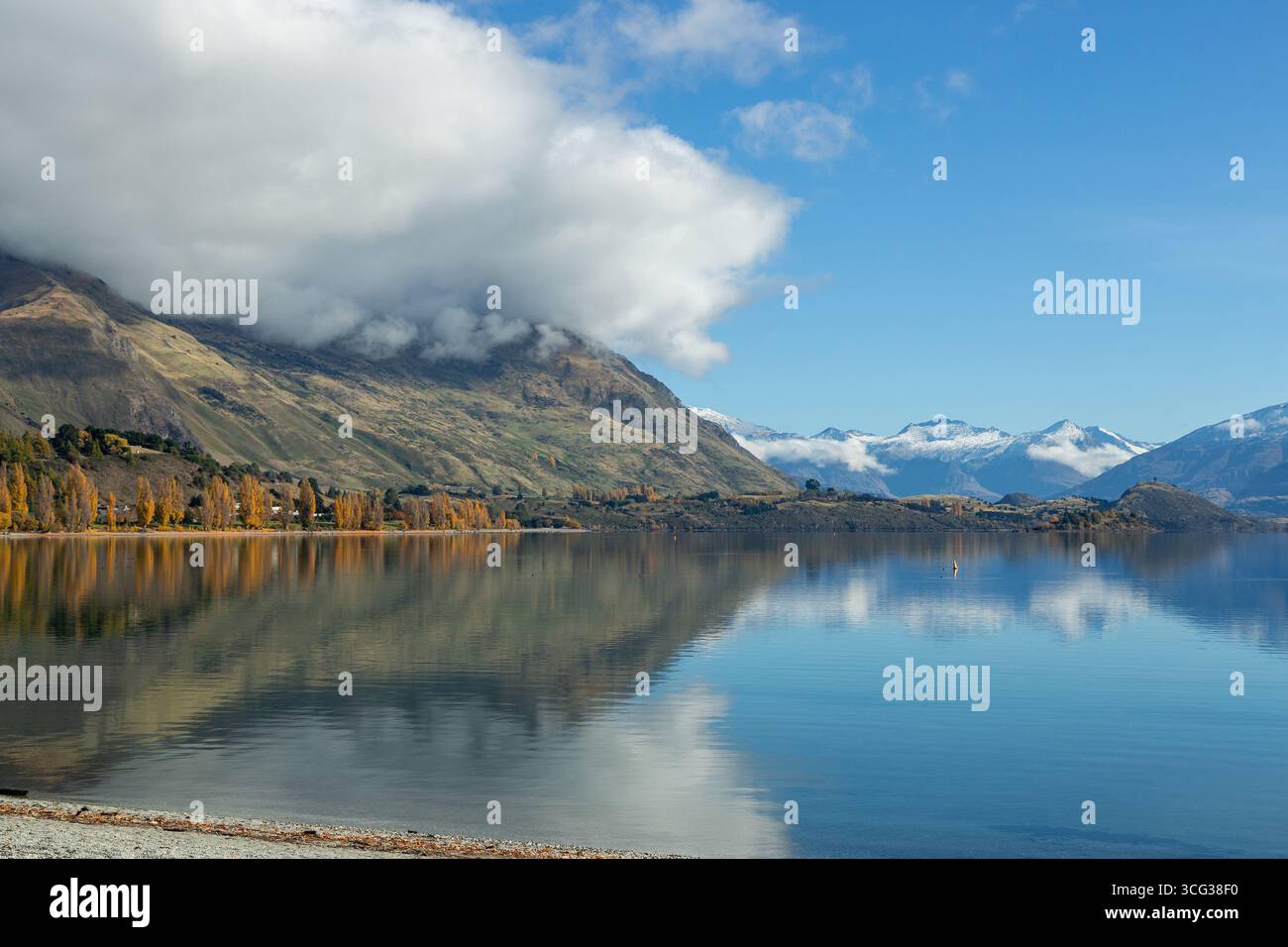 Beautiful blue sky reflections on a calm Lake Wanaka on a sunny Autumn day, Otago, New Zealand Stock Photo