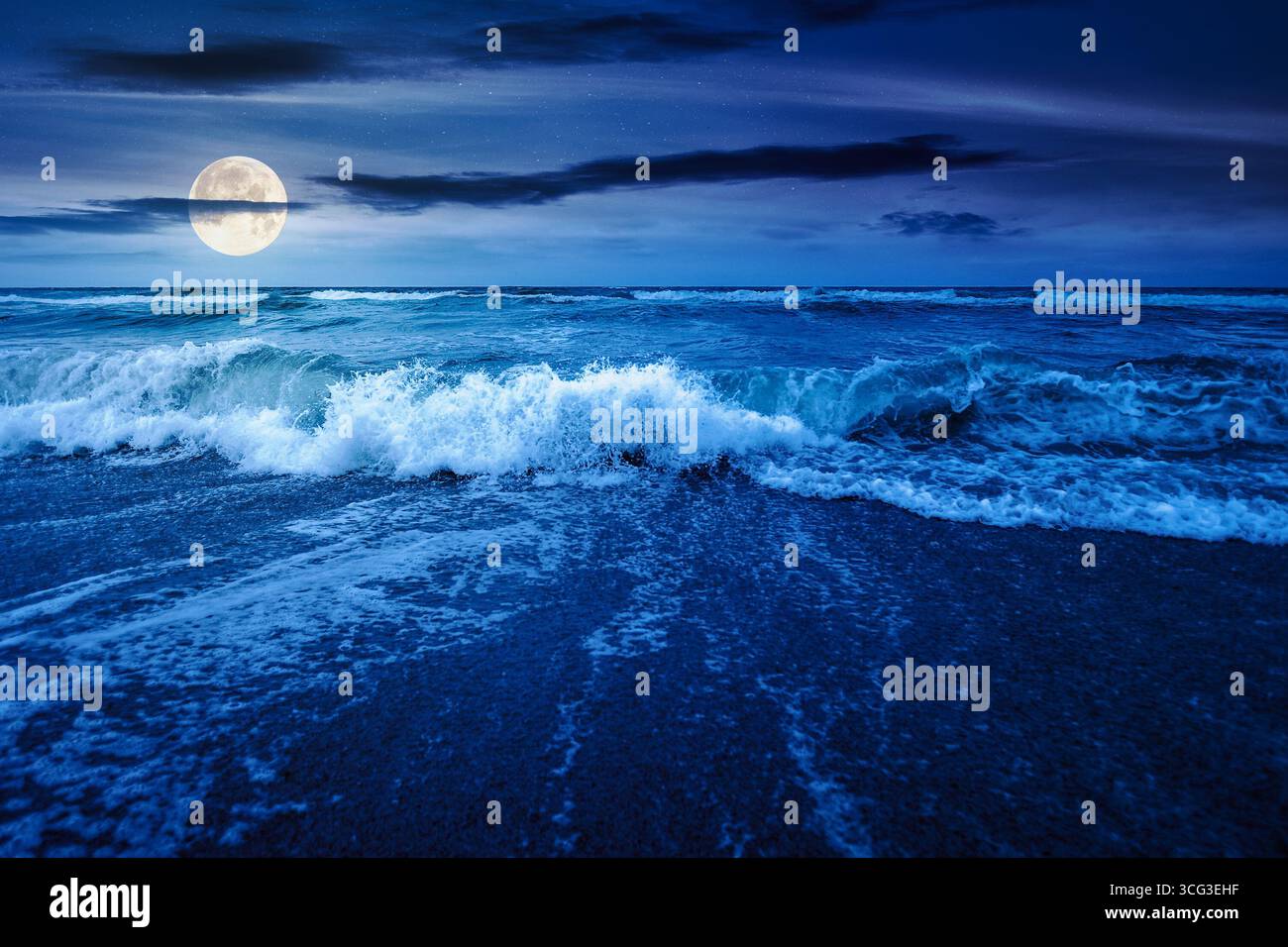 sea tide before storm at night. wave splash with foam on wet sandy beach in full moon light. windy weather on velvet season. dramatic seascape backgro Stock Photo