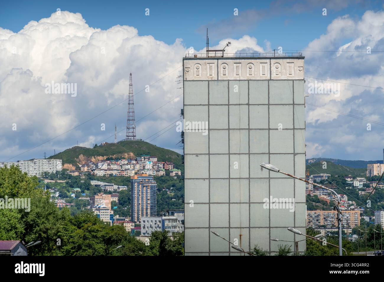 Vladivostok, Russia: Primorye hills with Soviet-era buildings and the radio Tower in soft morning light. Stock Photo