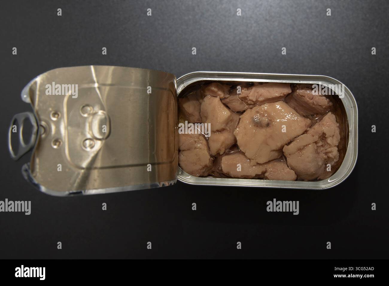 Cod Fish Can Open tin can with cod liver in oil on dark background. Concept of ...