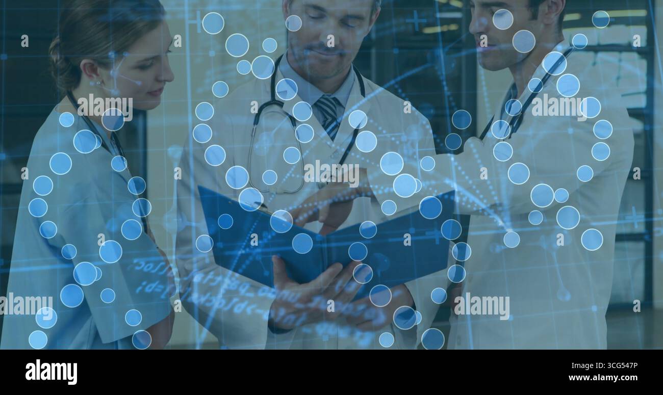 Reviewing patient data medical team pointing at blue binder in clinic ...