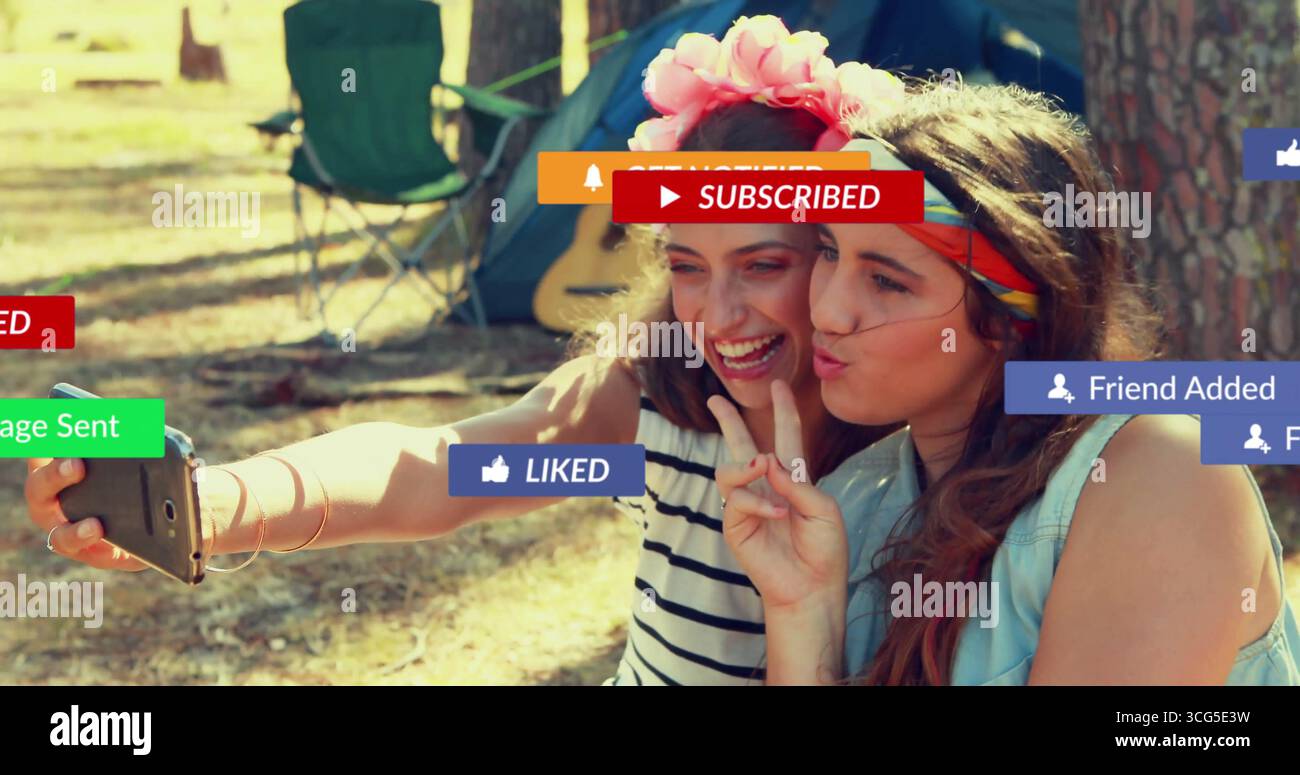 Smiling friends wearing headbands snapping selfie at campsite, with ...