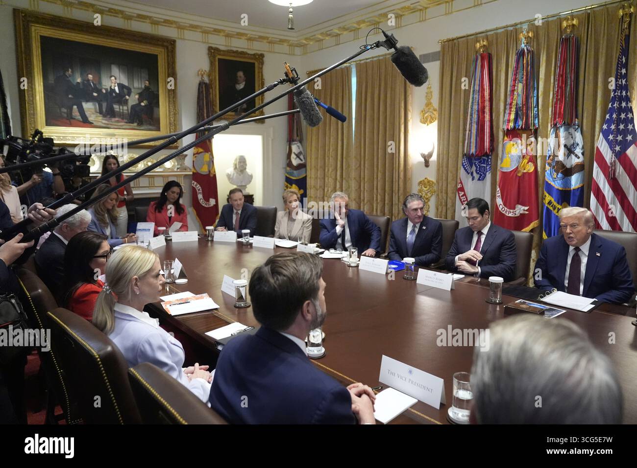 President Donald Trump, right, across from Vice President JD Vance and ...