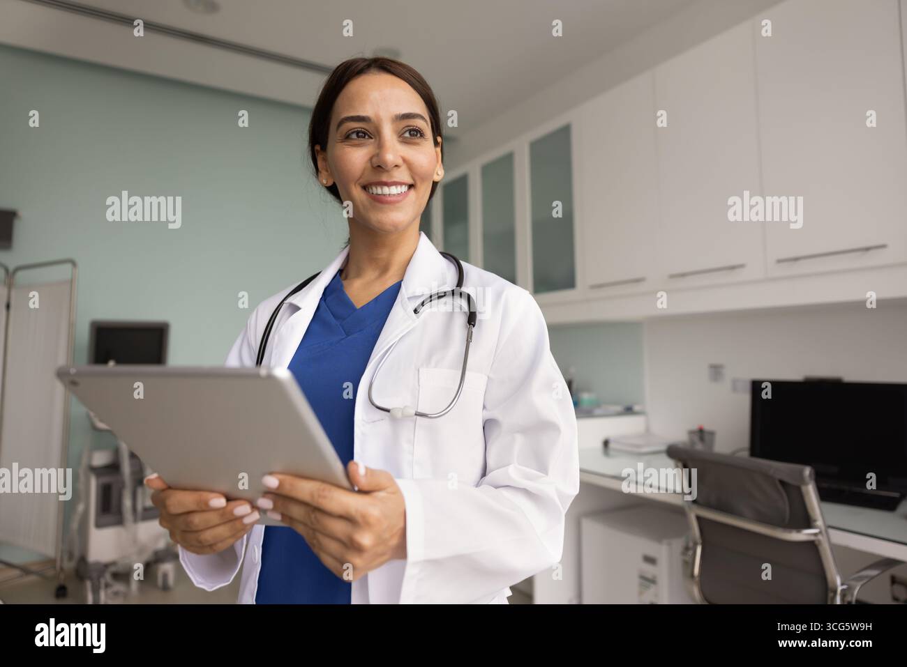 Confident successful medical professional woman using digital tablet Stock Photo