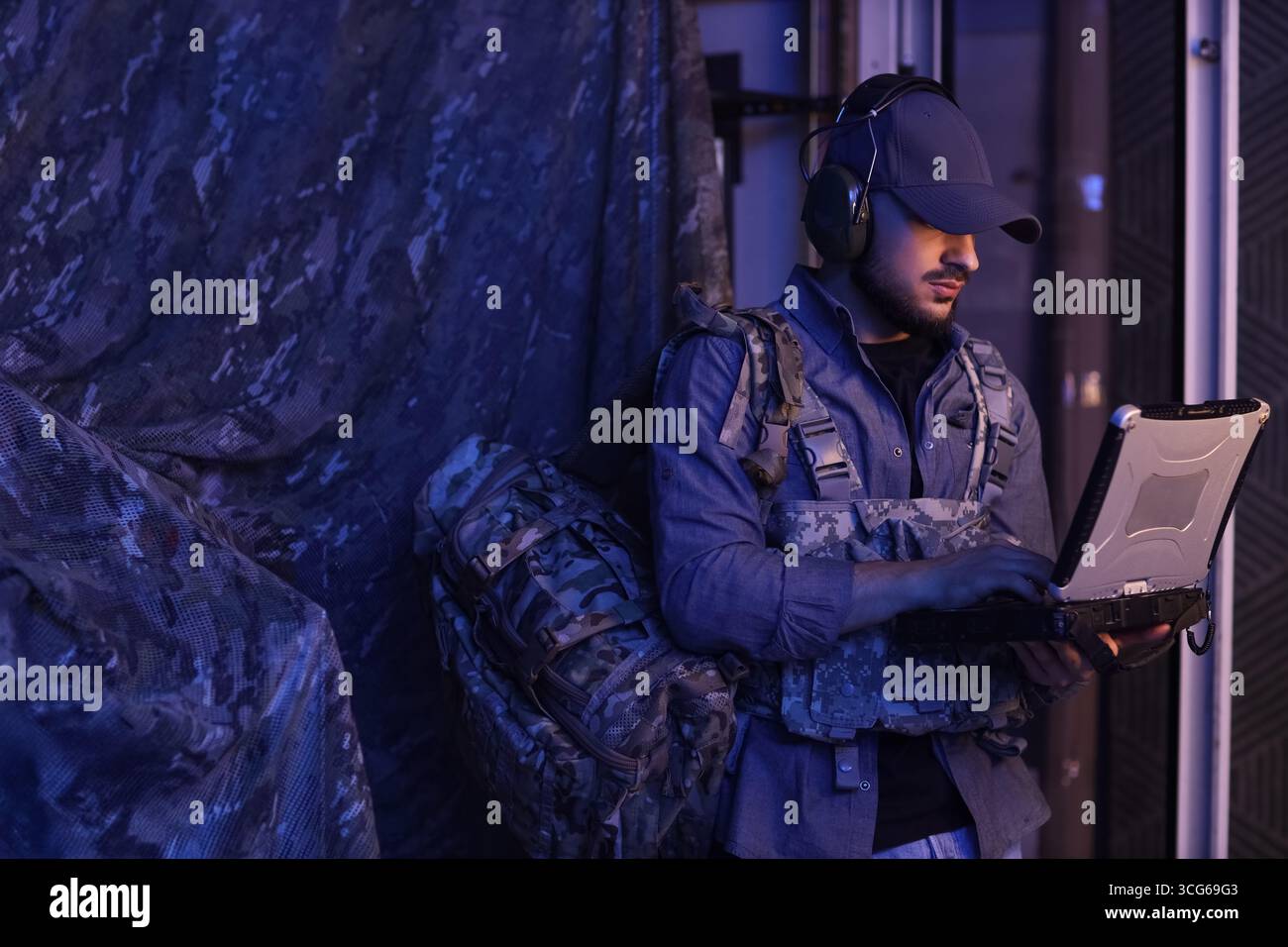 Soldier working with military laptop in command center at night Stock ...