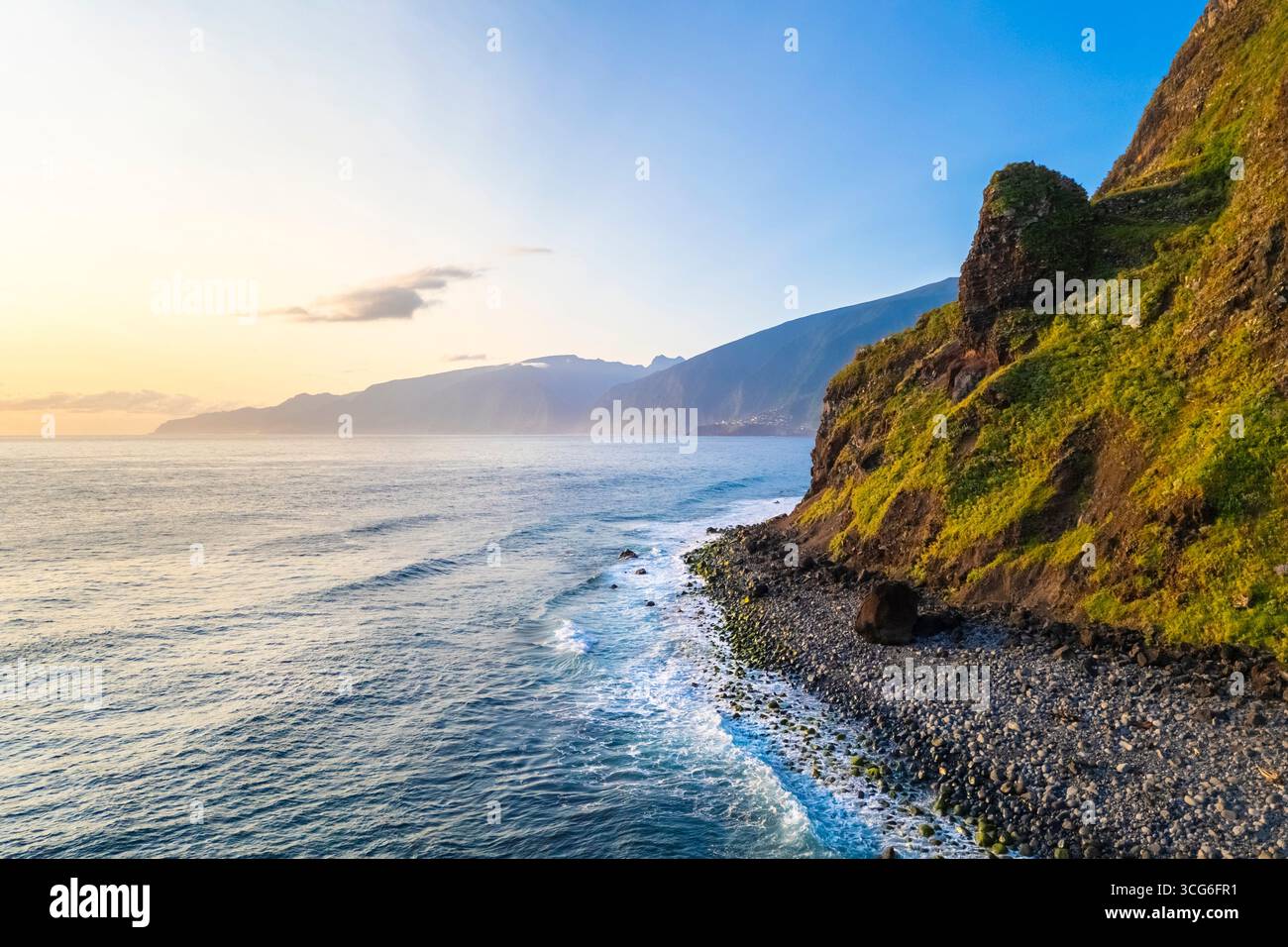 Aerial view of the coastline and crashing waves near Ribeira da Janela at sunrise. Ribeira da Janela, Madeira, Portugal, Europe. Stock Photo