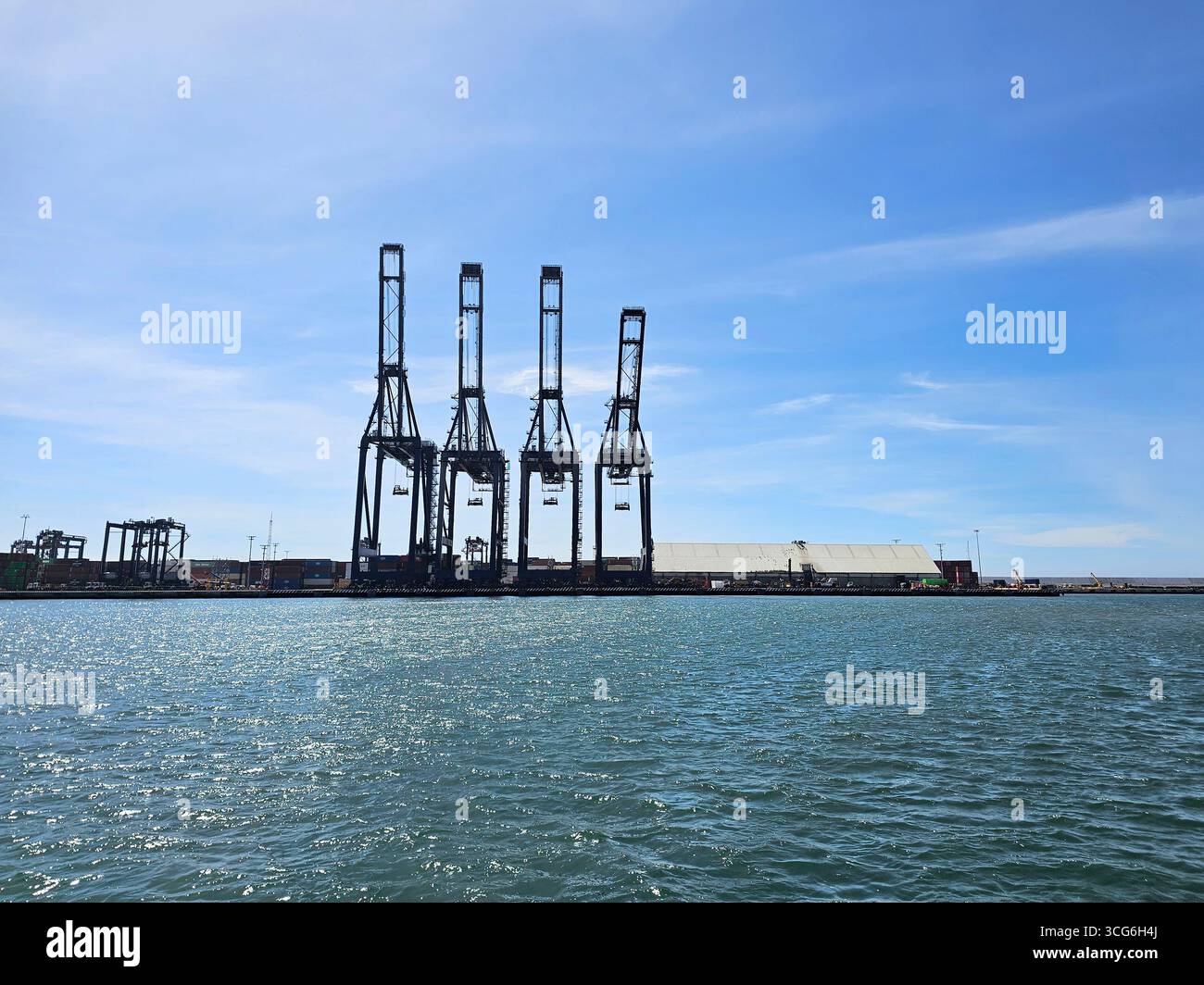 Ensenada, Baja California, Mexico - Mar 16, 2025: Harbor cranes are ...