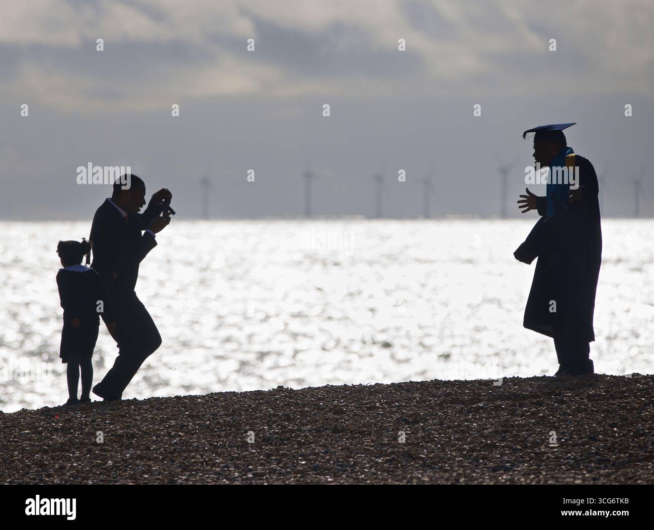 Silhouette of a Brighton University graduate donning university gown ...