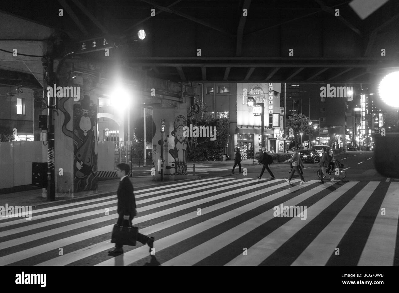 Urban/street Runder A nighttime city scene featuring pedestrians crossing the street under ...