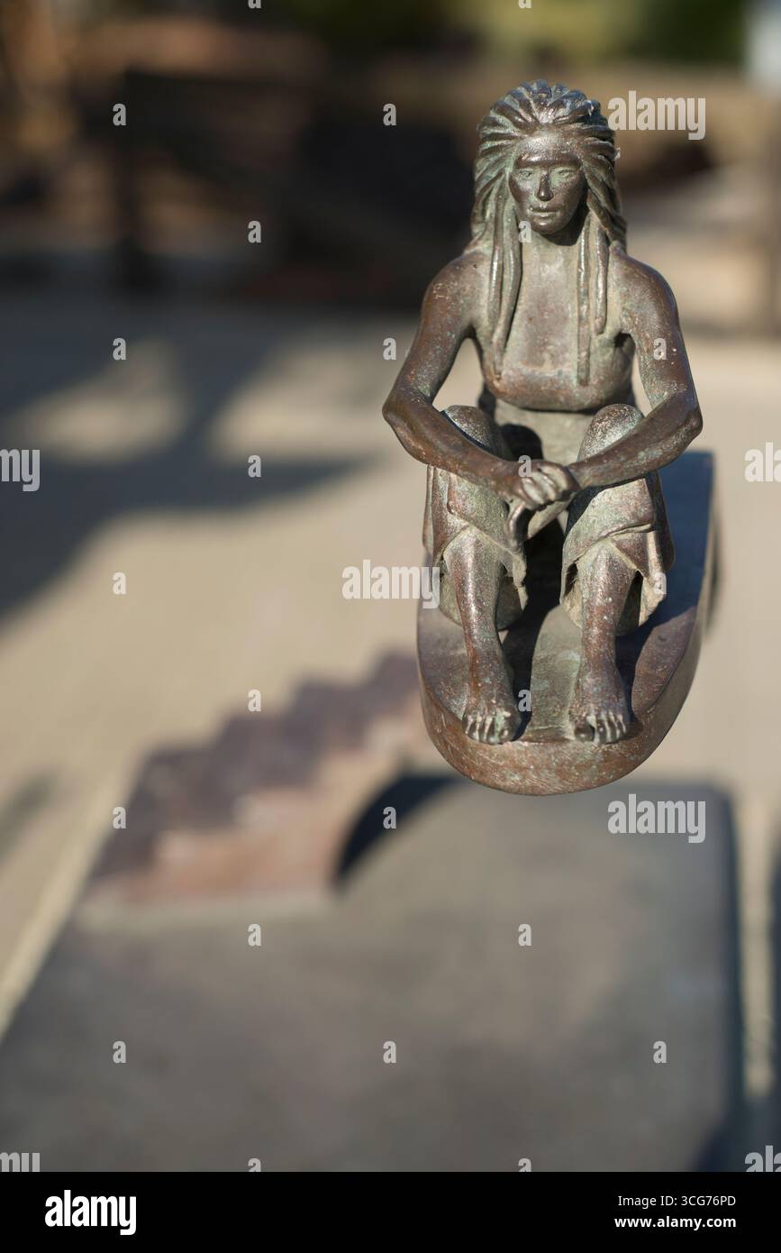 Bronze woman scanning the horizon and sitting at the top of a staircase. An artistic statue combining sculpture and architecture, the work of E. Walls Stock Photo