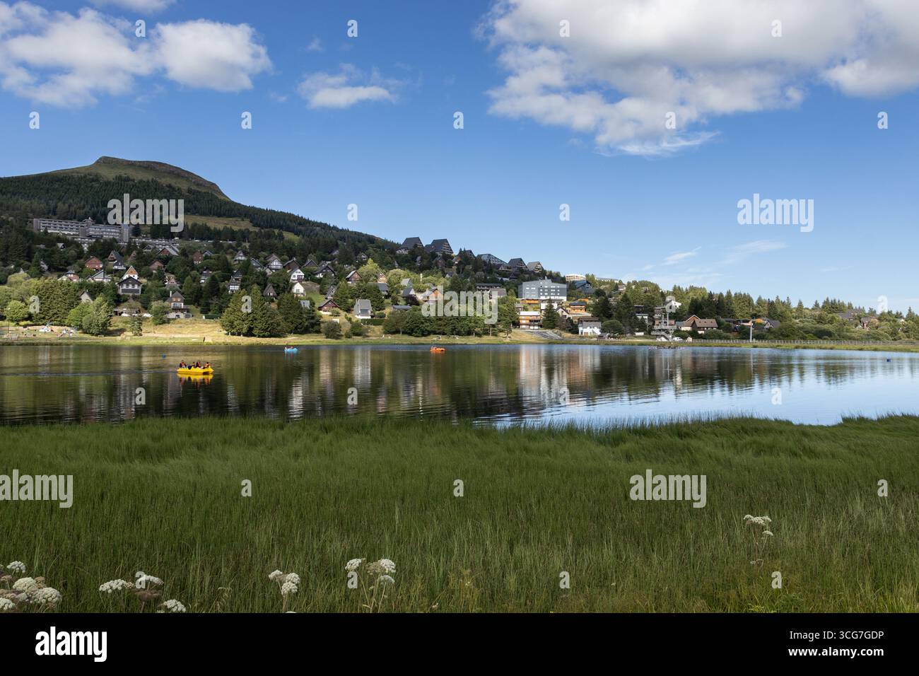 Summer evening view with beautiful light, of Lac des Hermines (lake) at Super Besse ski resort, near Besse-et-Saint-Anastaise, in France. Copy space a - Stock Image
