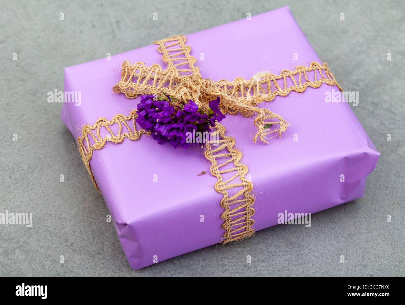 light purple gift with a rustic twine ribbon and a simple purple flower ...