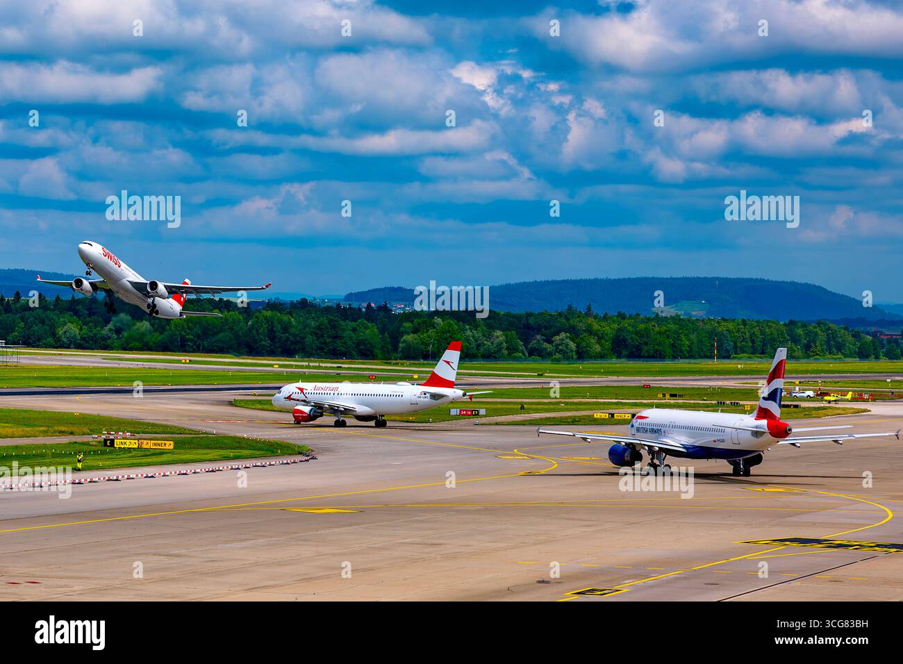 British Airways and Austrian and Swiss Airlines Passenger Airplane Taxiing and Take Off on Runway in a Sunny Summer Day From the Airport in Kloten, Zu Stock Photo