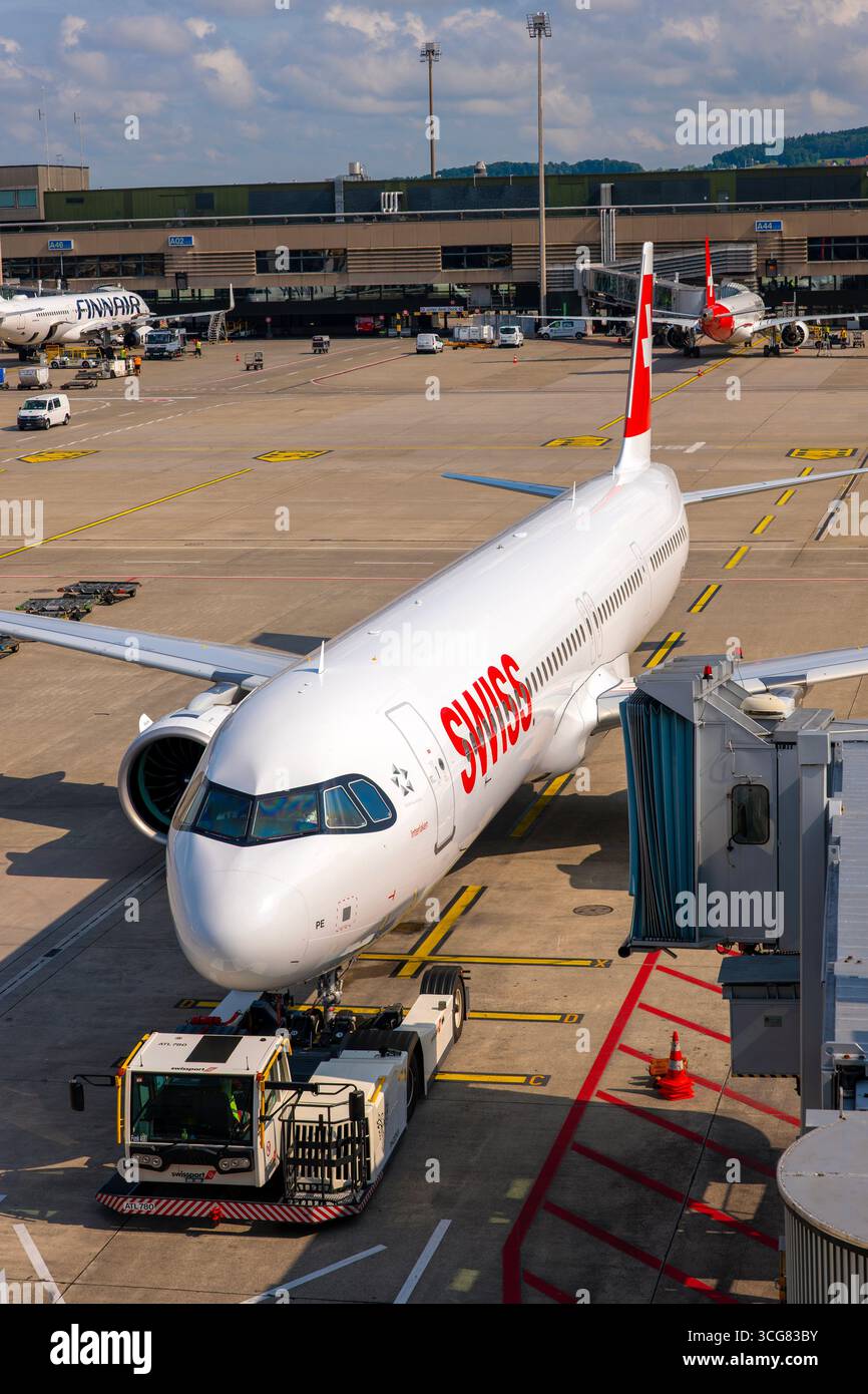 Zurich Airport and Passenger Airplane and Boarding Bridge Gate on Airfield in a Sunny Summer Day From the Airport in Kloten, Zurich, Zurich Canton, Sw Stock Photo