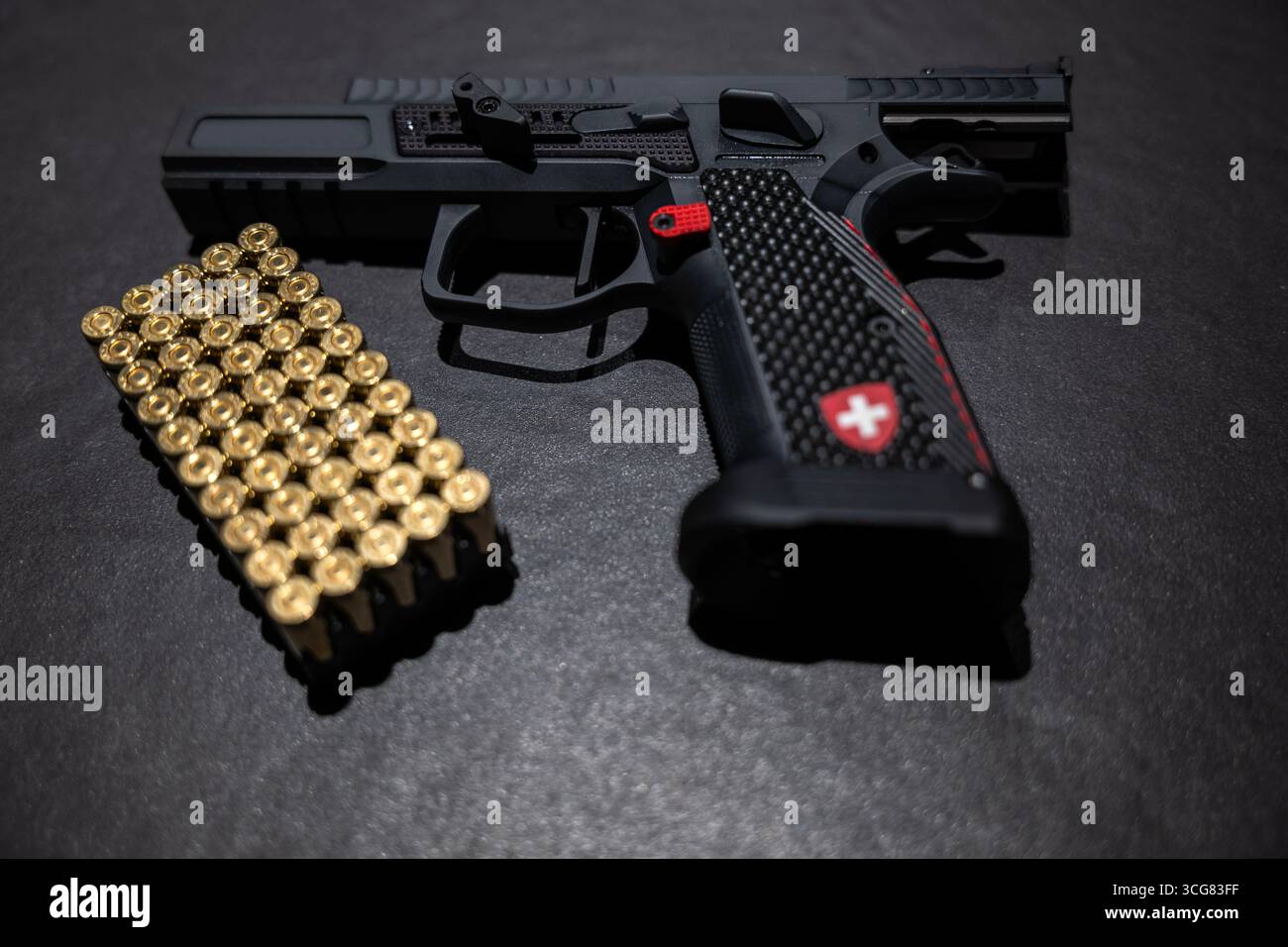 Modern Elegant Sport Handgun with Gas Pedal and Skirt on Grey Background in Switzerland. Stock Photo