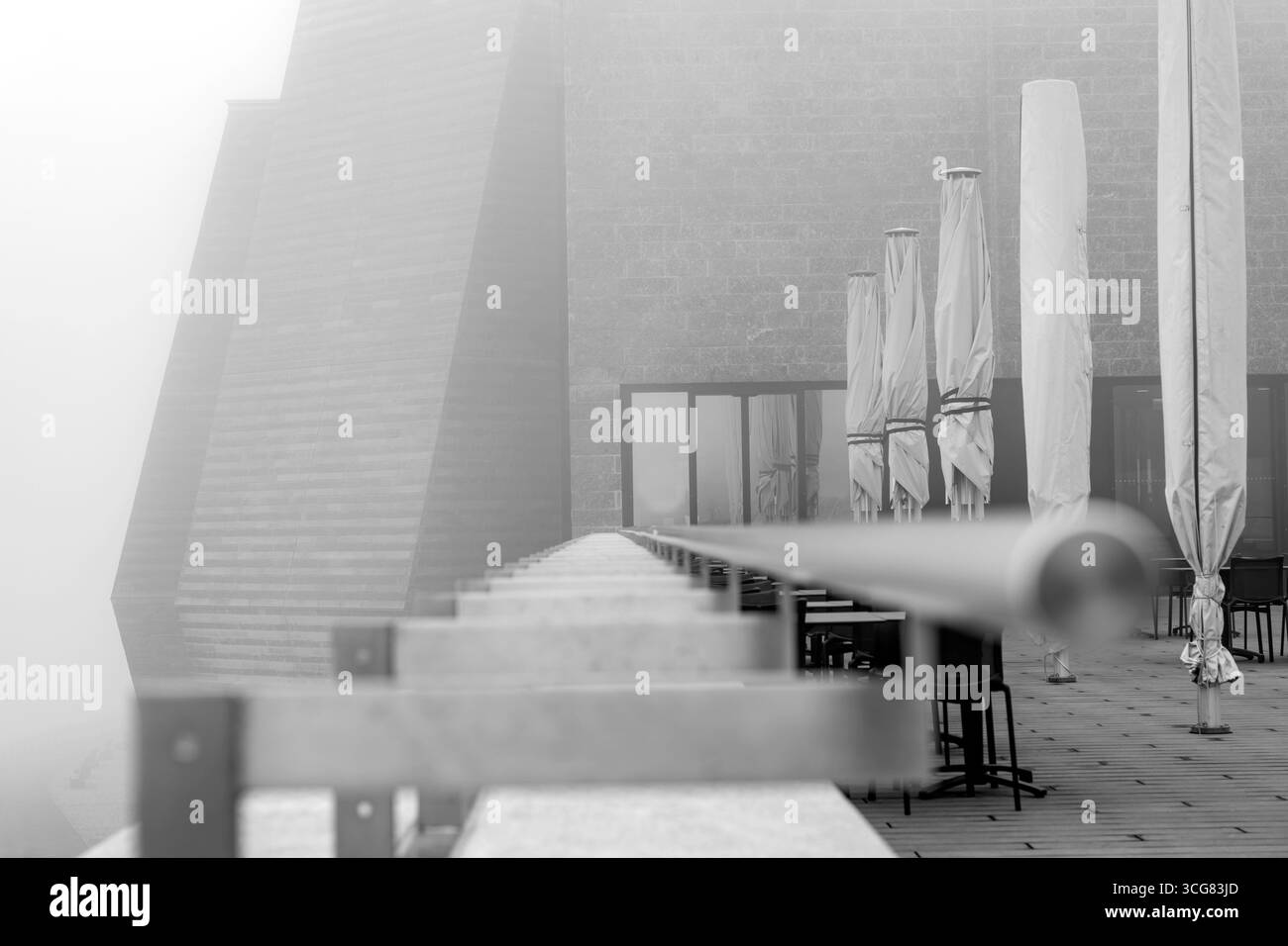 Modern Restaurant Terrace with Railing in the Clouds in a Cloudy Day in Monte Generoso, Ticino, Switzerland. Stock Photo