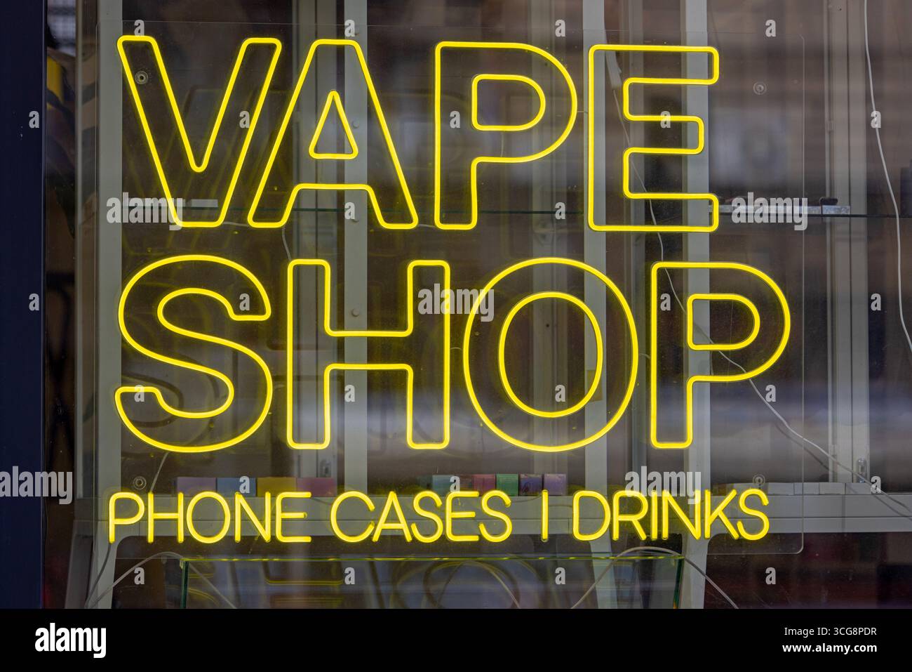 Yellow Neons in Store Window Vape Shop Phone Cases and Drinks Close up Stock Photo
