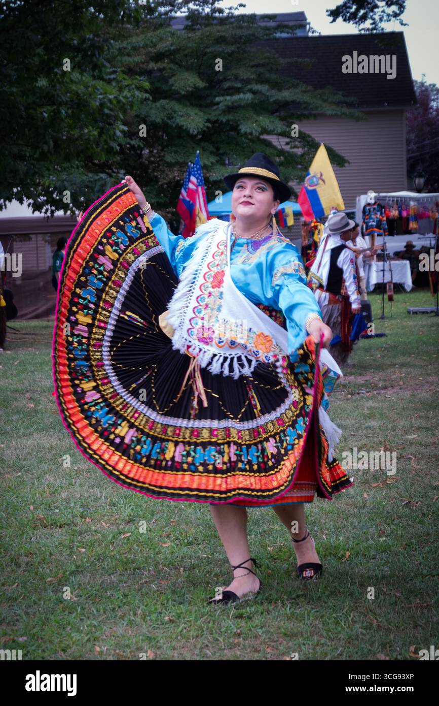 A middle aged dancer spins at the Ecuadorian culture Day celebration in Barnhart Park, Sleepy Hollow, Westchester, New York. Stock Photo