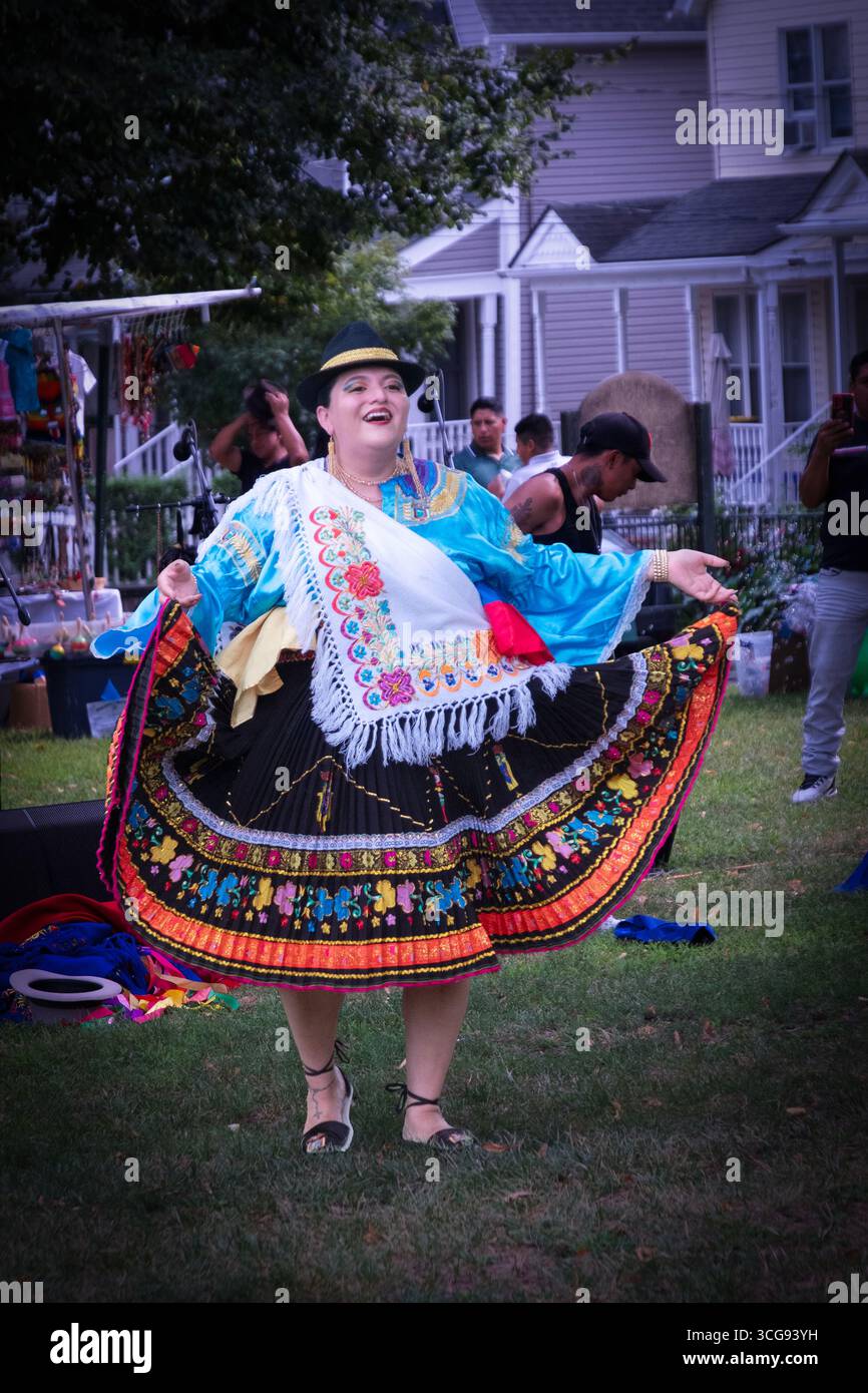 A middle aged dancer spins at the Ecuadorian culture Day celebration in Barnhart Park, Sleepy Hollow, Westchester, New York. Stock Photo