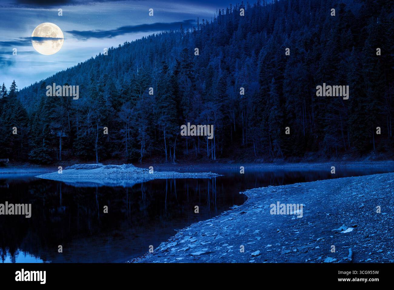scenic landscape by the lake in autumn forest at night. beautiful scenery of national park in fall season in full moon light. colorful environment ref Stock Photo